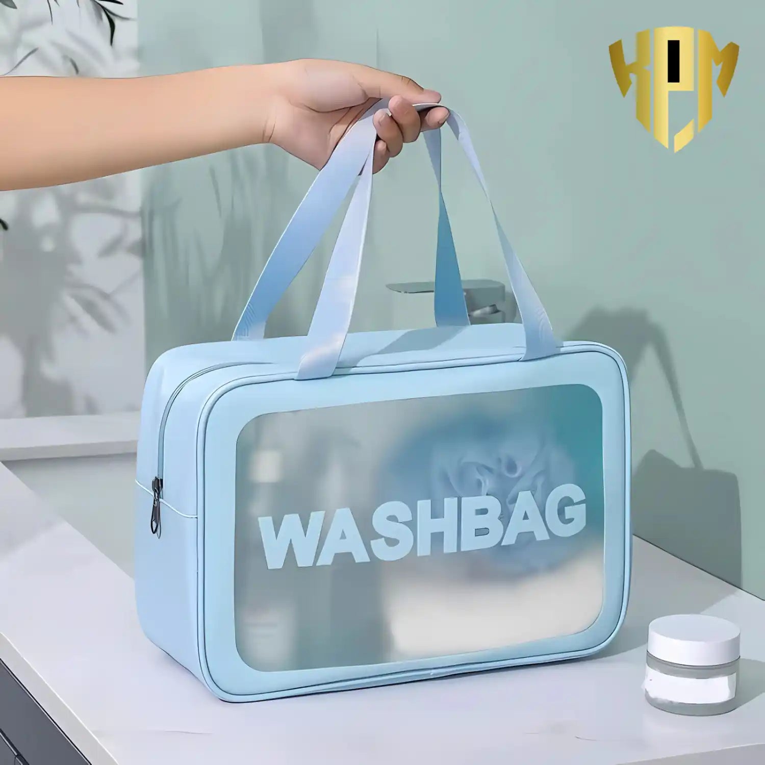 KPM WORLD™ portable blue travel wash bag with reinforced dual carry handles, spacious storage, waterproof construction, and transparent front panel for easy organization.